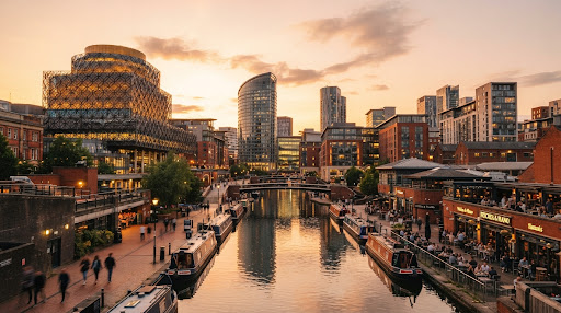 Birmingham canal basin at sunset framed by the Library of Birmingham and modern city architecture